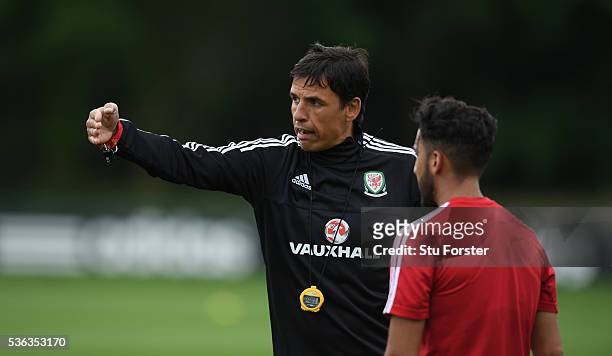 Wales player Neil Taylor listens to manager Chris Coleman during Wales training at the Vale hotel complex on June 1, 2016 in Cardiff, Wales.