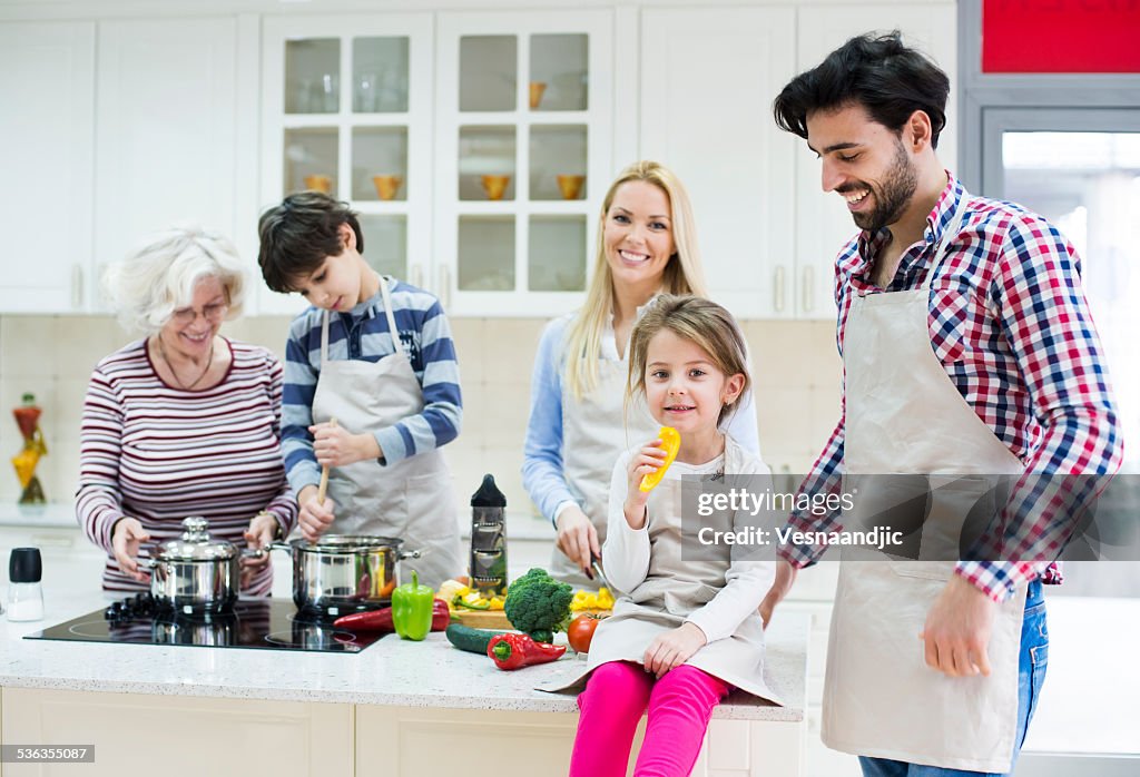 Beautiful family preparing healthy food in kitchen