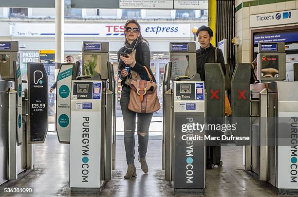 two women passing the turnstile to enter subway station - entering turnstile stock pictures, royalty-free photos & images