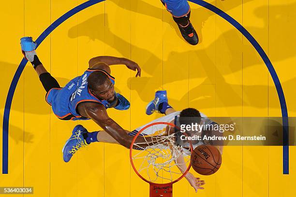 Klay Thompson of the Golden State Warriors drives to the basket around Kevin Durant of the Oklahoma City Thunder in Game One of the Western...