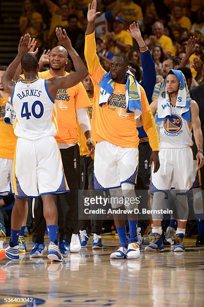 Harrison Barnes and Draymond Green of the Golden State Warriors high five in Game One of the Western Conference Finals against the Oklahoma City...