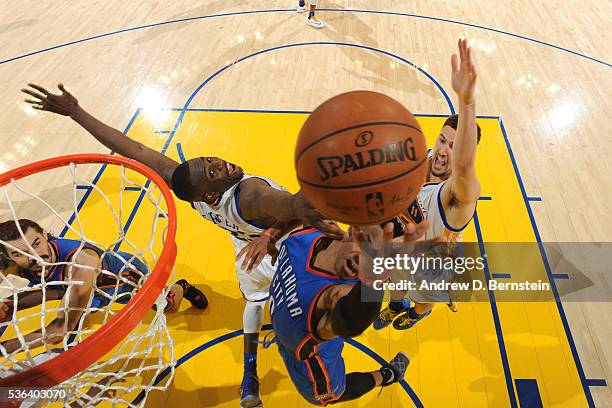 Russell Westbrook of the Oklahoma City Thunder drives to the basket around Draymond Green of the Golden State Warriors in Game One of the Western...