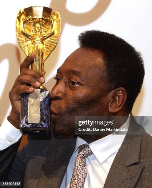 Pele with a replica Jules Rimet trophy attends a photocall for the Pele: THE COLLECTION at Julien Auctions on June 1, 2016 in London, England