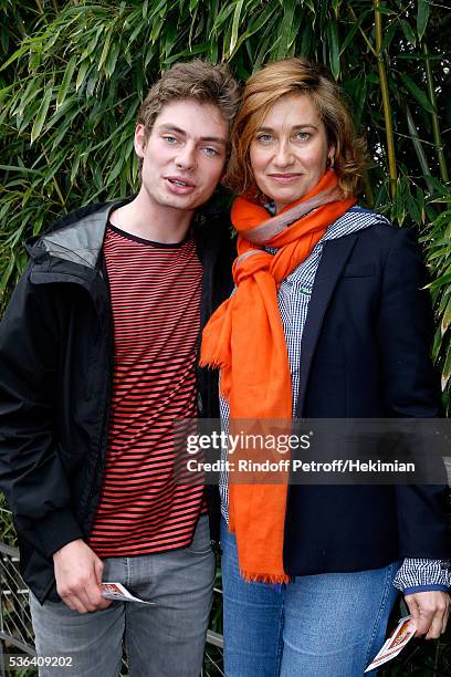 Actress Emmanuelle Devos and his son Raphael attend Day Eleven of the 2016 French Tennis Open at Roland Garros on June 1, 2016 in Paris, France.