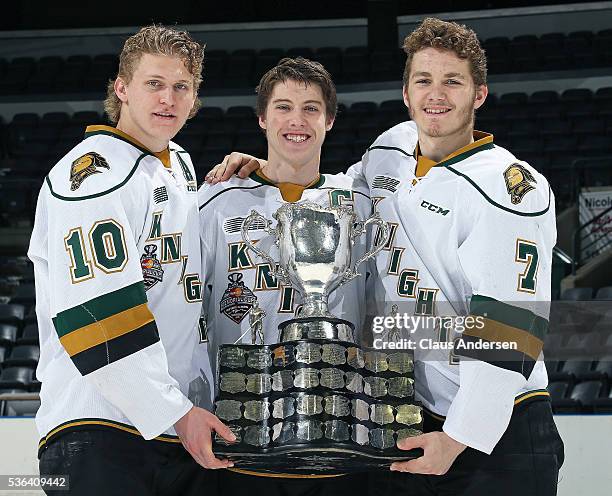 Christian Dvorak, Mitchell Marner, and Matthew Tkachuk of the London Knights pose with the 2016 Memorial Cup trophy at Budweiser Gardens on May 31,...