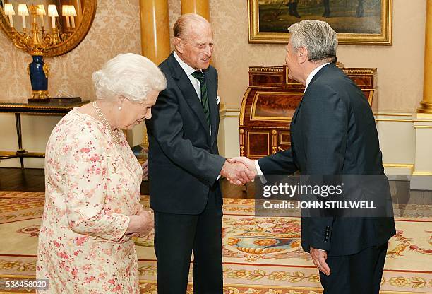 Britain's Queen Elizabeth II , and her husband Britain's Prince Philip, Duke of Edinburgh , greet German President Joachim Gauck during a private...