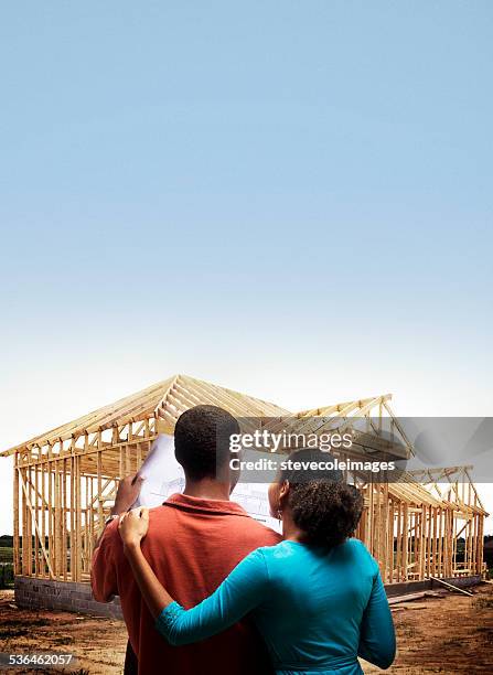 couple lookint at home - housing loan stockfoto's en -beelden