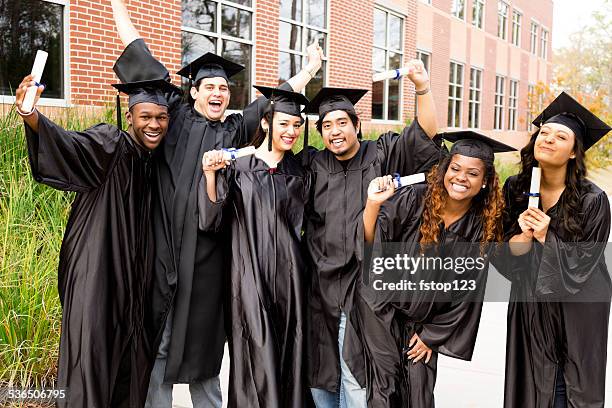 education: diverse group of friends excited after college graduation. diplomas. - graduation group stock pictures, royalty-free photos & images