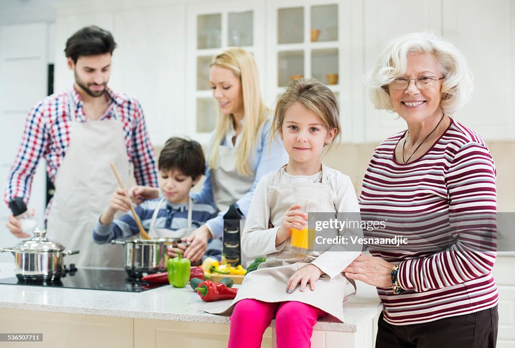 Beautiful family preparing healthy food in kitchen