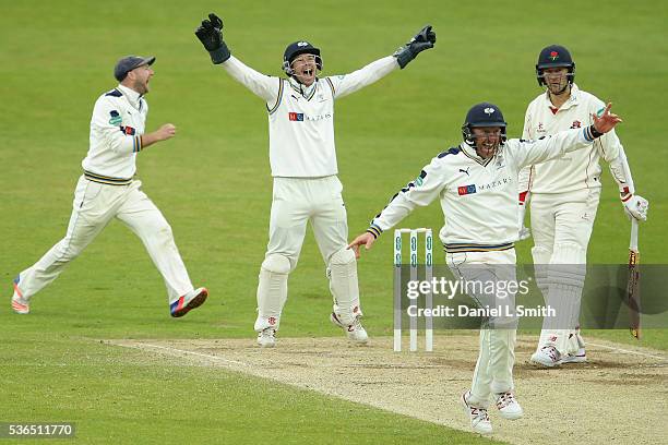 Andy Hodd and Andrew Gale of Yorkshire celebrate as Simon Kerrigan of Lancashire is trapped LBW during day four of the Specsavers County...