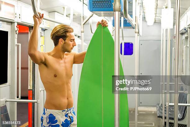 young surfer in subway - city to surf stock pictures, royalty-free photos & images