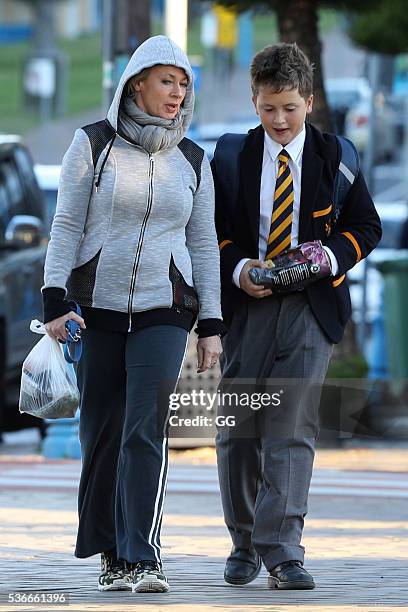 Host of 'The Living Room', Amanda Keller enjoys an evening stroll at Bondi with her dog and son on May 27, 2016 in Sydney, Australia.