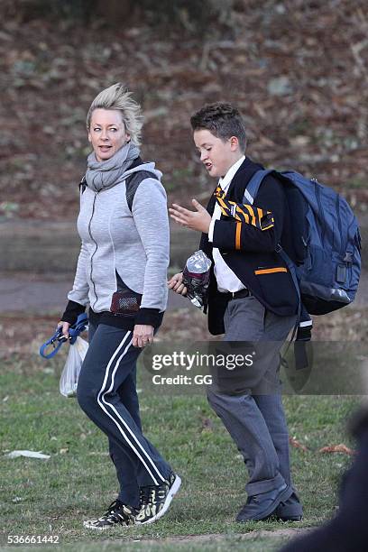 Host of 'The Living Room', Amanda Keller enjoys an evening stroll at Bondi with her dog and son on May 27, 2016 in Sydney, Australia.