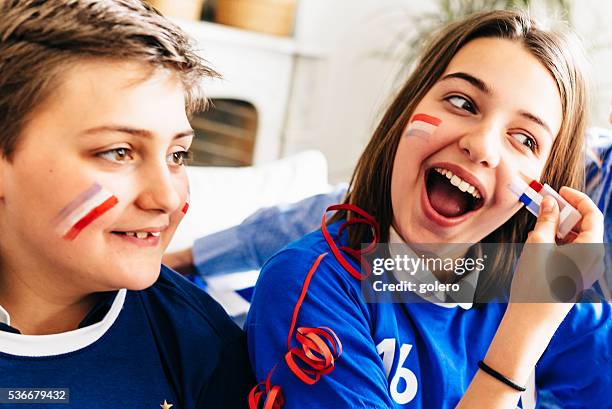 french boy and girl in soccer outfit with face painting - france supporter stock pictures, royalty-free photos & images