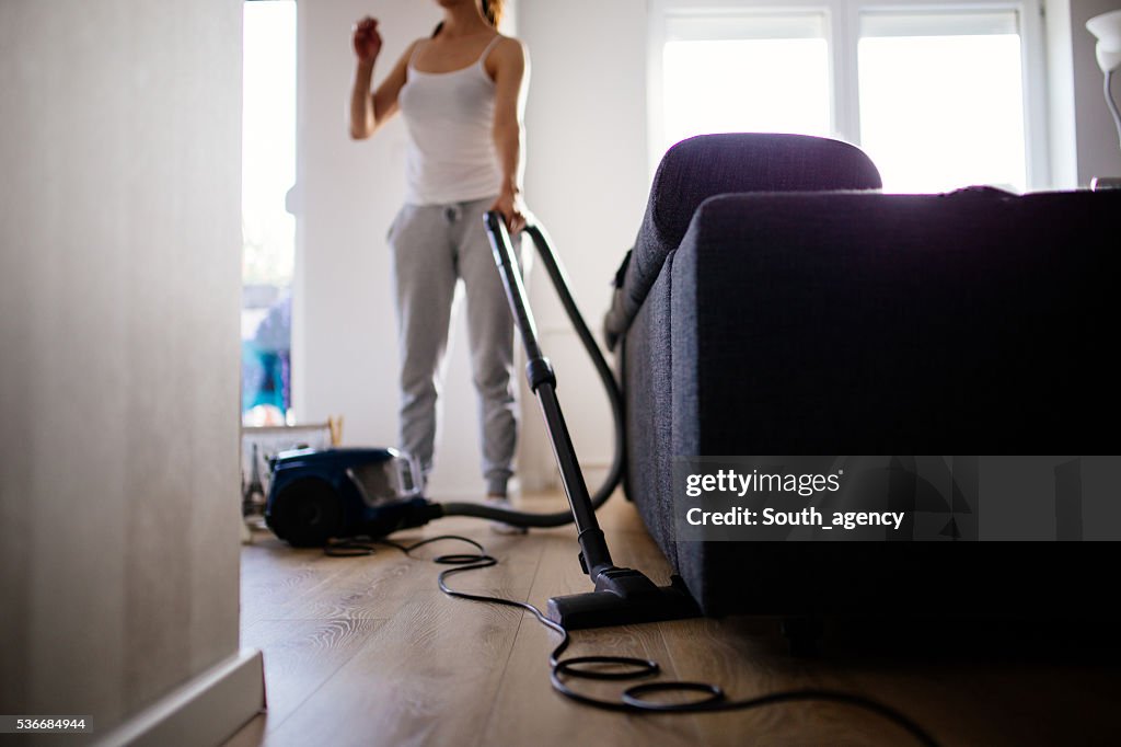 Woman vacuuming living room