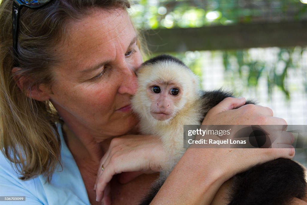 Close up of woman holding monkey