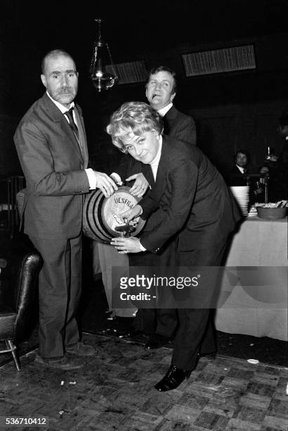 Picture released on December 9, 1969 of French actors Jacques Dufilho , Pierre Mondy and Jacqueline Maillan celebrating the Beaujolais Nouveau, at...