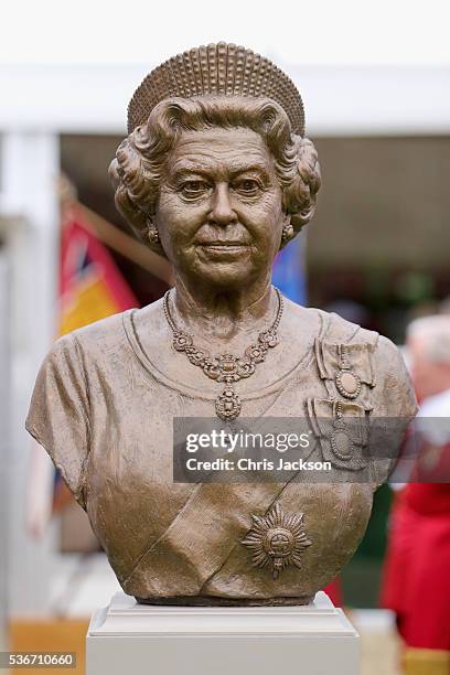 Queen Elizabeth II watches the unveiling of a bronze bust of herself during a visit to the Honourable Artillery Company on June 1, 2016 in London,...