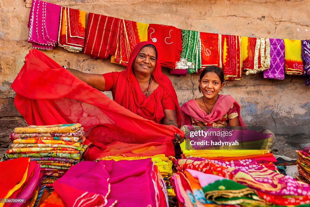 Indian women selling colorful fabrics