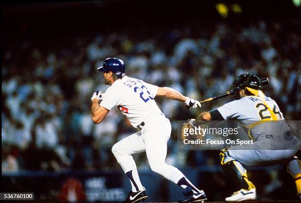Kirk Gibson of the Los Angeles Dodgers swing and hits a game winning pitch-hit home run in the bottom of the ninth inning of game one against the...