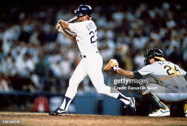 Kirk Gibson of the Los Angeles Dodgers bats in the bottom of the ninth inning of game one against the Oakland Athletics during the 1988 World Series,...