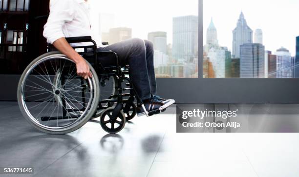 man using wheel chair - man wheel chair stock pictures, royalty-free photos & images