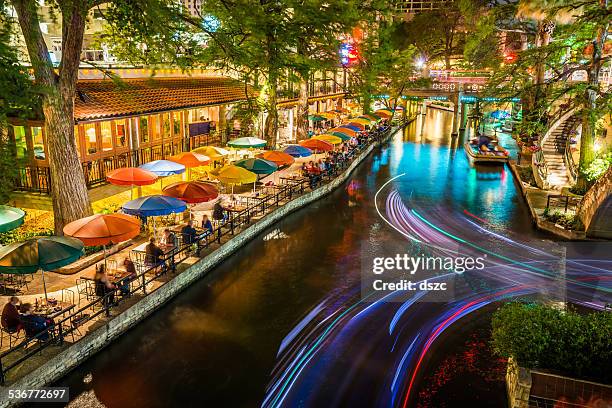 san antonio riverwalk, texas, scenic river canal tourism umbrellas night - restaurant night ストックフォトと画像