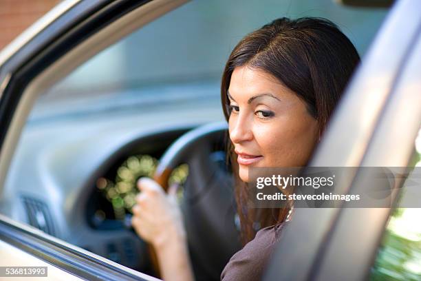 hispanic woman looking back to for safety. - representing stock pictures, royalty-free photos & images
