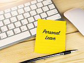 Personal leave on sticky note on work desk