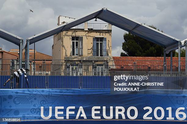 Man work on the fanzone site for the UEFA Euro 2016 on the Prado beaches in Marseille where supporters will gather to watch the games on big screens,...