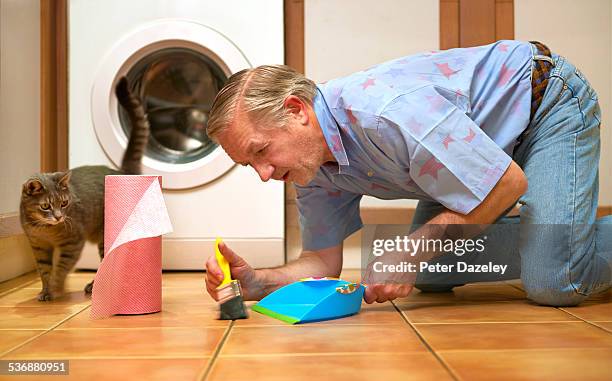man with ocd cleaning kitchen floor - obsessive stockfoto's en -beelden