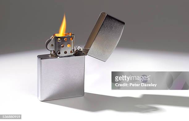 cigarette lighter with flame - lighter fotografías e imágenes de stock