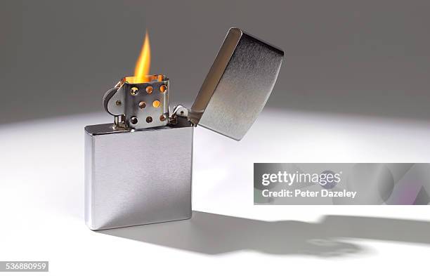 cigarette lighter with flame - cigarette lighter stock pictures, royalty-free photos & images