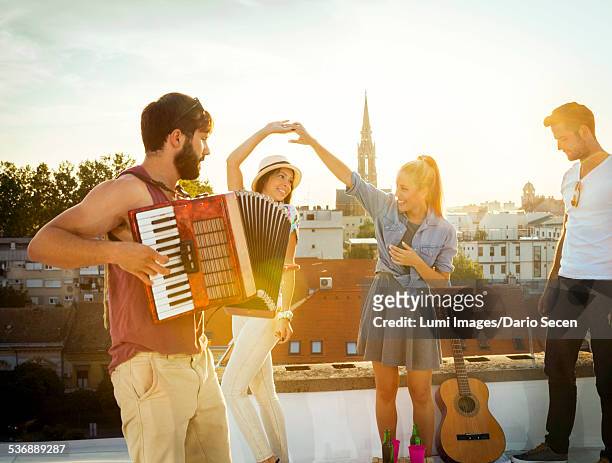young people having fun at rooftop party - bandoneon bildbanksfoton och bilder