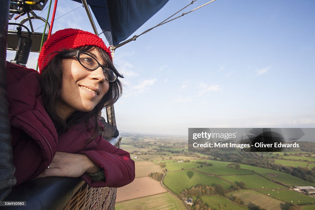 Woman travelling in a hot air balloon.