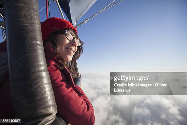 woman travelling in a hot air balloon. - heissluftballon stock-fotos und bilder