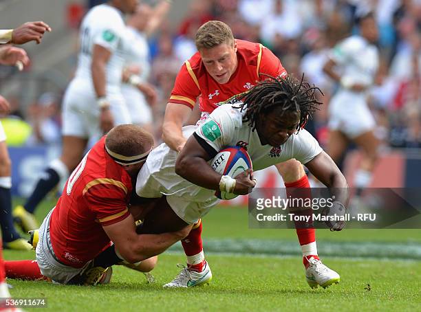 Marlon Yarde of England is tackled by James King of Wales during the Old Mutual Wealth Cup between England and Wales at Twickenham Stadium on May 29,...