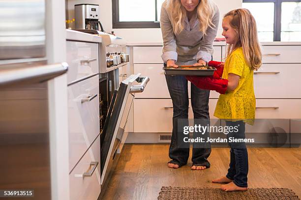 a mom baking with her children. - mt cook fotografías e imágenes de stock