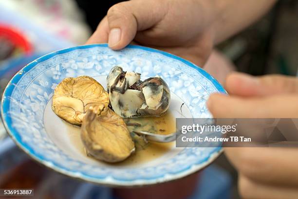 eating balut (balot) at a street stall - cambodia pattern stock pictures, royalty-free photos & images