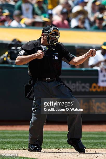 Umpire Andy Fletcher calls a third strike during the fifth inning between the Oakland Athletics and the Detroit Tigers at the Oakland Coliseum on May...