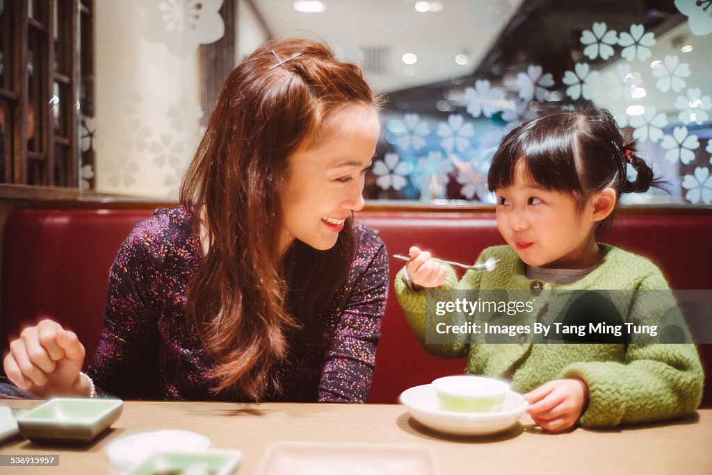 Daughter having dessert with mom in restaurant