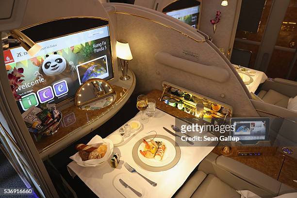 Meal lies served in a compartment in first class on board an Emirates A380 passenger plane at the ILA 2016 Berlin Air Show on June 1, 2016 in...