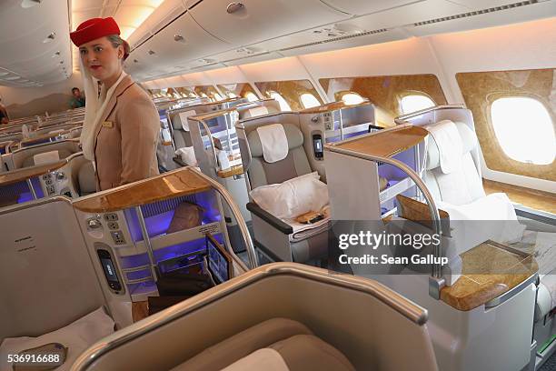 Stewardess waits to welcome visitors in the business class section on board an Emirates A380 passenger plane at the ILA 2016 Berlin Air Show on June...