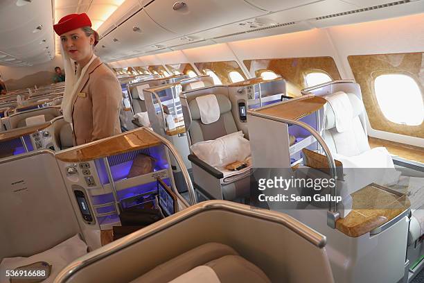 Stewardess waits to welcome visitors in the business class section on board an Emirates A380 passenger plane at the ILA 2016 Berlin Air Show on June...
