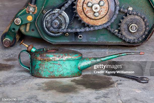 maintaining a lawnmower - lata de óleo imagens e fotografias de stock