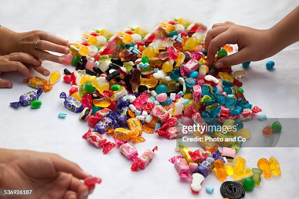 child with lots of candy - candies photos et images de collection