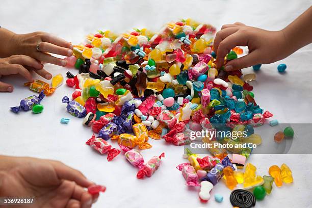 child with lots of candy - キャンディ ストックフォトと画像