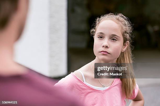 angry girl looking at father outdoors - children fighting stock pictures, royalty-free photos & images