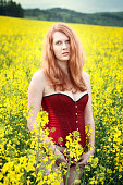 Beautiful redhead in the oilseed Rape