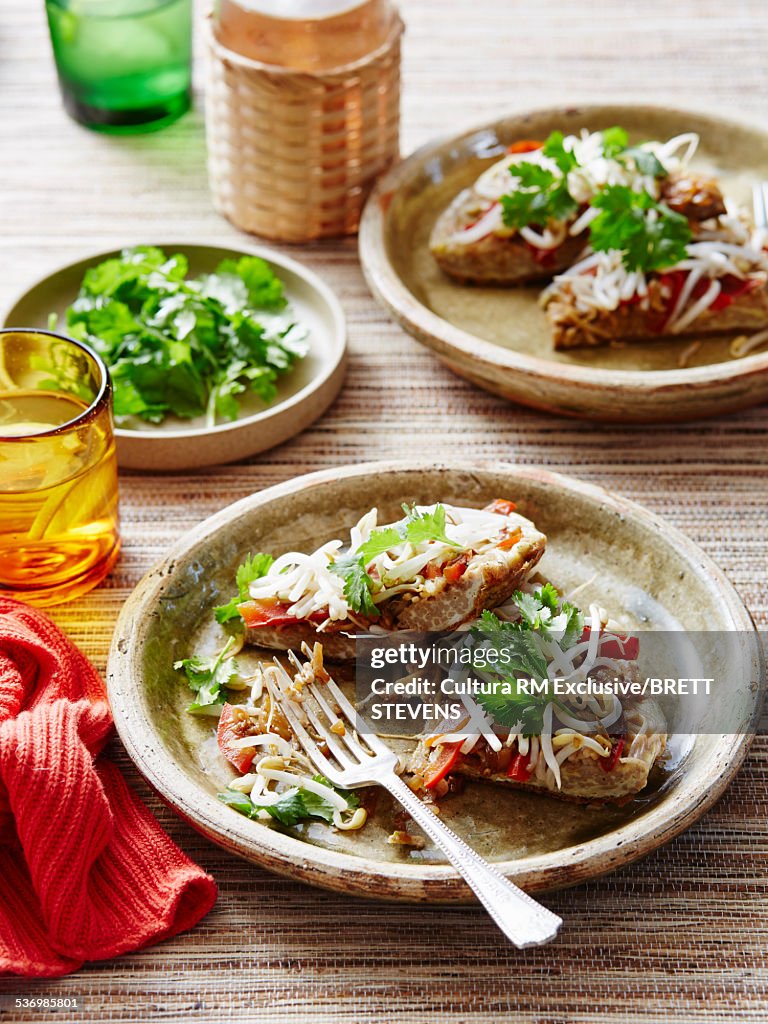 Chinese eggs with noodles, coriander and alfalfa with water